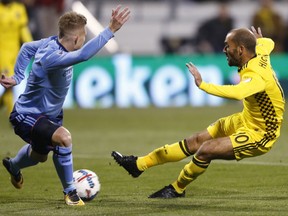 Columbus Crew's Federico Higuain, right, shoots past New York City FC's Alexander Ring during the first half of an MLS Eastern Conference semi-final soccer game Tuesday, Oct. 31, 2017, in Columbus, Ohio. (AP Photo/Jay LaPrete)
