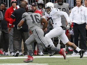 Penn State linebacker Koa Farmer, right, returns a fumble against Ohio State during the first half of an NCAA college football game Saturday, Oct. 28, 2017, in Columbus, Ohio. (AP Photo/Jay LaPrete)
