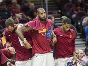 Cleveland Cavaliers' LeBron James, center, Kevin Love, left, and Iman Shumpert stand during a time out against the Chicago Bulls during the second half of an NBA preseason basketball game in Cleveland, Tuesday, Oct. 10, 2017. The Bulls won 108-94. (AP Photo/Phil Long)