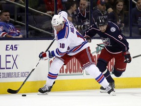 New York Rangers forward J.T. Miller, left, works for the puck against Columbus Blue Jackets forward Artemi Panarin, of Russia, during the first period of an NHL hockey game in Columbus, Ohio, Friday, Oct. 13, 2017. (AP Photo/Paul Vernon)