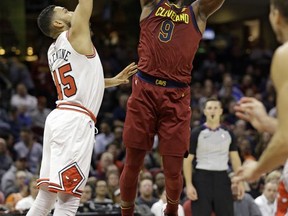 Cleveland Cavaliers' Dwyane Wade, right, shoots over Chicago Bulls' Denzel Valentine in the first half of an NBA basketball game, Tuesday, Oct. 24, 2017, in Cleveland. (AP Photo/Tony Dejak)