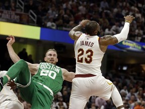 Boston Celtics' Gordon Hayward (20) falls as Cleveland Cavaliers' LeBron James (23) reaches for a loose ball in the first half of an NBA basketball game, Tuesday, Oct. 17, 2017, in Cleveland. Hayward broke his left ankle on a play. (AP Photo/Tony Dejak)