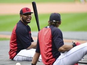 Cleveland Indians' Edwin Encarnacion, left, talks with Erik Gonzalez during a team workout, Tuesday, Oct. 10, 2017, in Cleveland. The Indians will play the New York Yankees Wednesday in Game 5 of the ALDS. (AP Photo/David Dermer)