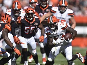 Cleveland Browns running back Isaiah Crowell (34) runs for a first down in the first half of an NFL football game against the Cincinnati Bengals, Sunday, Oct. 1, 2017, in Cleveland. (AP Photo/David Richard)