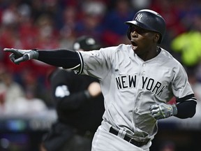 New York Yankees' Didi Gregorius points to the dugout after hitting a two-run home run off Indians starting pitcher Corey Kluber during the third inning of Game 5 of their American League Division Series on Wednesday night in Cleveland.