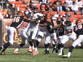 Cleveland Browns quarterback DeShone Kizer (7) is pressured in the second half of an NFL football game against the Cincinnati Bengals, Sunday, Oct. 1, 2017, in Cleveland. (AP Photo/David Richard)