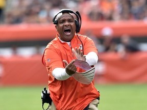 Cleveland Browns head coach Hue Jackson tries to get a timeout during the second half of an NFL football game against the New York Jets, Sunday, Oct. 8, 2017, in Cleveland. (AP Photo/David Richard)