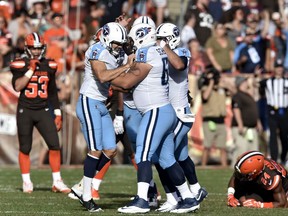 Tennessee Titans kicker Ryan Succop, left, celebrates with teammates after making a game-winning 47-yard field goal in overtime in an NFL football game Sunday, Oct. 22, 2017, in Cleveland. The Titans won 12-9 in overtime. (AP Photo/David Richard)