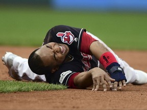 Cleveland Indians' Edwin Encarnacion grimaces after rolling his ankle trying to get back to second base in the second inning against the New York Yankees in Game 2 of a baseball American League Division Series, Friday, Oct. 6, 2017, in Cleveland. (AP Photo/David Dermer)
