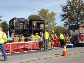 Fire crews standby after battling a farmhouse fire that killed multiple people Thursday, Oct. 26, 2017, just east of Fostoria Ohio. A dog was also killed. (Ryan Dunn/The Blade via AP)