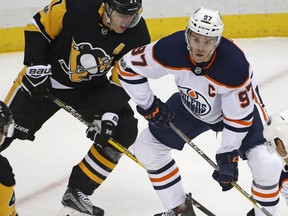Edmonton Oilers forward Connor McDavid (right) battles Pittsburgh Penguins forward Evgeni Malkin on Oct. 24.