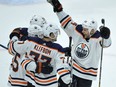 Zack Kassian (44) celebrates with Oilers teammates Mark Letestu (55), Ryan Nugent-Hopkins (93) and Oscar Klefbom (77) after Letestu scored in overtime to give Edmonton a 2-1 win over the Blackhawks in Chicago on Thursday night.