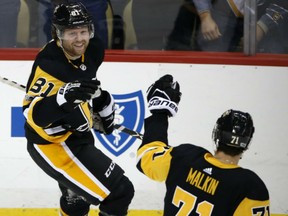 Phil Kessel celebrates his game-winning goal in overtime against the Edmonton Oilers with Penguins teammate Evgeni Malkin during their game in Pittsburgh on Tuesday night. The Penguins won 2-1.