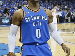 Oklahoma City Thunder guard Russell Westbrook (0) roars to fans before an NBA basketball game against the New York Knicks in Oklahoma City, Thursday, Oct. 19, 2017. (AP Photo/Sue Ogrocki)