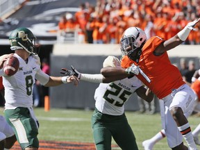 Baylor quarterback Zach Smith (8) passes under pressure from Oklahoma State linebacker Calvin Bundage (1), who is blocked by Baylor's Tristan Ebner (25) in the first quarter of an NCAA college football game in Stillwater, Okla., Saturday, Oct. 14, 2017. (AP Photo/Sue Ogrocki)