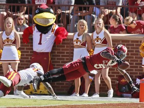 Oklahoma wide receiver CeeDee Lamb (9) dives into the end zone with a touchdown in front of Iowa State defensive back Reggie Wilkerson, left, in the first quarter of an NCAA college football game in Norman, Okla., Saturday, Oct. 7, 2017. (AP Photo/Sue Ogrocki)