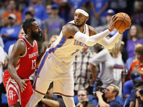 Oklahoma City Thunder forward Carmelo Anthony (7) is guarded by Houston Rockets guard James Harden (13) during the first quarter of an NBA preseason basketball game in Tulsa, Okla., Tuesday, Oct. 3, 2017. (AP Photo/Sue Ogrocki)