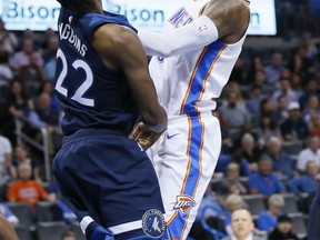 Oklahoma City Thunder forward Paul George, right, shoots over Minnesota Timberwolves guard Andrew Wiggins (22) in the third quarter of an NBA basketball game in Oklahoma City, Sunday, Oct. 22, 2017. Minnesota won 115-113. (AP Photo/Sue Ogrocki)