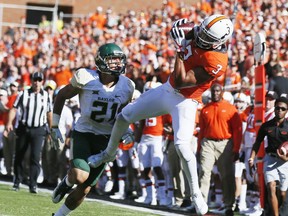 Oklahoma State wide receiver Marcell Ateman (3) catches a pass in front of Baylor cornerback Blake Lynch (21) in the second an NCAA college football game in Stillwater, Okla., Saturday, Oct. 14, 2017. (AP Photo/Sue Ogrocki)
