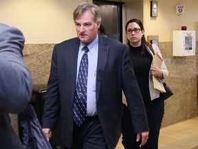 FILE - In this Friday, June 30, 2017 file photo, Shannon Kepler, left, arrives with his legal team for afternoon testimony in his trial in Tulsa, Okla. An Oklahoma judge has ruled that Kepler will face a fourth murder trial in the 2014 killing of his daughter's black boyfriend. (AP Photo/Sue Ogrocki, File)