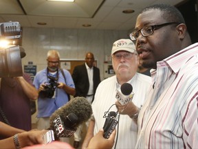 FILE - In this Monday, July 13, 2015 file photo, Marq Lewis, of We The People, speaks with the media in Tulsa, Okla., Monday, July 13, 2015. Tulsa activist Marq Lewis with We the People Oklahoma said that defense attorneys in the trial of ex-Tulsa police officer Shannon Kepler have been booting potential jurors based on skin color. Kepler goes on trial for the fourth time in less than a year in the 2014 fatal shooting of his daughter's black boyfriend. (AP Photo/Sue Ogrocki, File)