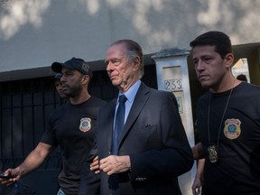 Brazilian Olympic Committee president Carlos Nuzman (centre) is escorted from his home in Rio de Janeiro by federal police on Oct. 5.