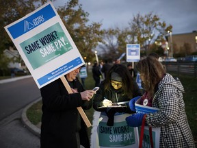 Picketers sign in as they arrive at the Humber College Lakeshore campus picket line on Monday, Oct. 16, 2017.