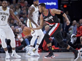 Portland Trail Blazers guard Evan Turner, right, dribbles around New Orleans Pelicans forward Darius Miller during the first half of an NBA basketball game in Portland, Ore., Tuesday, Oct. 24, 2017. (AP Photo/Craig Mitchelldyer)