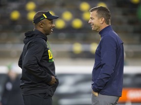 Oregon head coach Willie Taggart, left, talks with California head coach Justin Wilcox before their NCAA college football game Saturday, Sept. 30, 2017, in Eugene, Ore. (AP Photo/Chris Pietsch)