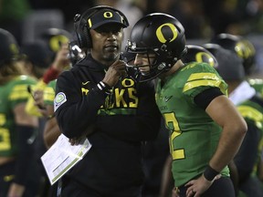 Oregon head coach Willie Taggart, left, talks to backup quarterback Taylor Allie after starting quarterback Justin Herbert left the field with an apparent injury during the first quarter against California in an NCAA college football game Saturday, Sept. 30, 2017, in Eugene, Ore. (AP Photo/Chris Pietsch)