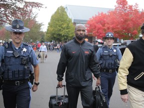 Oregon State interim head coach Cory Hall, center, walks to Reser Stadium before an NCAA college football game, in Corvallis, Ore., Saturday, Oct. 14, 2017. (AP Photo/Timothy J. Gonzalez)