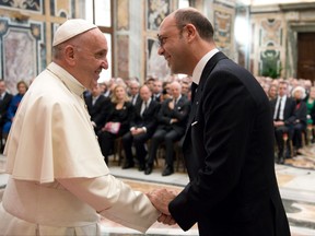 Pope Francis shakes hands with Italian Foreign Minister Angelino Alfano on the occasion of the Conference of International Humanitarian Law, at the Vatican, Saturday, Oct. 28, 2017. (L'Osservatore Romano/Pool Photo via AP)