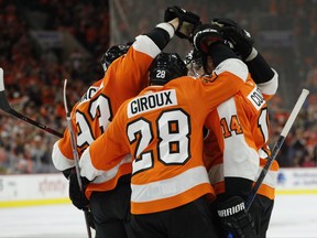 Philadelphia Flyers gather to celebrate the goal by Claude Giroux, center, during the second period of an NHL hockey game against the Washington Capitals, Saturday, Oct. 14, 2017, in Philadelphia. (AP Photo/Chris Szagola)