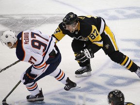 Pittsburgh Penguins' Sidney Crosby (87) tries to slow down Edmonton Oilers' Connor McDavid (97) in the third period of an NHL hockey game in Pittsburgh, Tuesday, Oct. 24, 2017. The Penguins won 2-1 in overtime. (AP Photo/Gene J. Puskar)