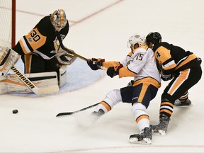 Nashville Predators' Craig Smith (15) loses the puck while skating in on Pittsburgh Penguins goalie Matt Murray as Justin Schultz (4) defends in the first period of the NHL hockey game, Saturday, Oct. 7, 2017, in Pittsburgh. (AP Photo/Keith Srakocic)