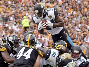 Jacksonville Jaguars running back Leonard Fournette (27) goes over Pittsburgh Steelers outside linebacker Tyler Matakevich (44) and the Steelers defense to score a touchdown in the second quarter of an NFL football game, Sunday, Oct. 8, 2017, in Pittsburgh. (AP Photo/Don Wright)