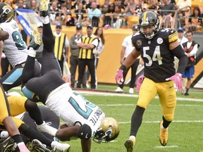 Jacksonville Jaguars running back Leonard Fournette (27) lands in the end zone to score a touchdown in front of Pittsburgh Steelers linebacker L.J. Fort (54) in the second quarter of an NFL football game, Sunday, Oct. 8, 2017, in Pittsburgh. (AP Photo/Fred Vuich)
