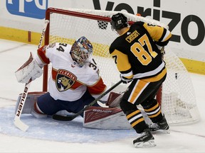 Pittsburgh Penguins' Sidney Crosby, right, scores a goal on Florida Panthers goalie James Reimer in the first period the NHL hockey game, Saturday, Oct. 14, 2017, in Pittsburgh. (AP Photo/Keith Srakocic)
