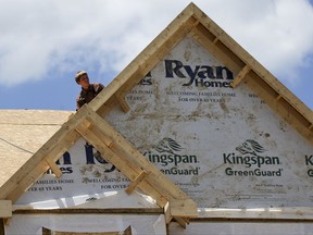 In this Thursday, June 1, 2017, photo, a builder works on the roof of a home under construction at a housing plan in Jackson Township, Butler County, Pa. On Tuesday, Oct. 17, 2017, the National Association of Home Builders/Wells Fargo releases its October index of builder sentiment. (AP Photo/Keith Srakocic)