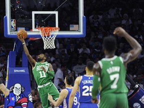 Boston Celtics' Kyrie Irving (11) drives to the basket past Philadelphia 76ers' Dario Saric (9) in the first half of an NBA basketball game, Friday, Oct. 20, 2017, in Philadelphia. (AP Photo/Michael Perez)