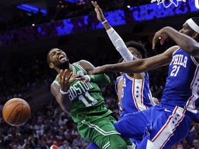 Boston Celtics' Kyrie Irving (11) gets his shot blocked by Philadelphia 76ers' Joel Embiid (21) in the second half of an NBA basketball game, Friday, Oct. 20, 2017, in Philadelphia. (AP Photo/Michael Perez)