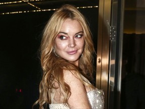 FILE - In this Oct. 16, 2016, file photo, actress Lindsay Lohan appears at the opening night of the Lohan Nightclub in Athens, Greece. Lohan posted a video to Instagram on Oct. 10, 2017, defending fired movie mogul Harvey Weinstein. (AP Photo/Yorgos Karahalis, File)