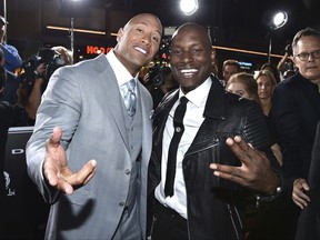 FILE - In this April 1, 2015, file photo, Dwayne Johnson, left, and Tyrese Gibson arrive at the premiere of "Furious 7" at the TCL Chinese Theatre IMAX in Los Angeles. Tyrese posted on Instagram Thursday, Oct. 5, 2017, that Johnson was a "clown" for agreeing to star in a spinoff film in the "Fast & Furious" franchise. (Photo by John Shearer/Invision/AP, File )