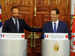 Tunisian Prime Minister Youssef Chahed, right, and his French counterpart Edouard Philippe attend a joint press conference in Tunis, Thursday, Oct. 5 2017. Philippe is on a one-day visit to Tunisia. (AP Photo/Hassene Dridi)