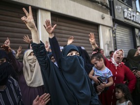 FILE - In this Thursday, July 20, 2017 file picture, women protesters shout slogans during a demonstration in the northern town of El Hoceima, Morocco. Since October 2016, the province of Al Hoceima, located in the Rif, is shaken by protests that began after the death of 31-year-old Mouhcine Fikri, a local vendor who was crushed in a garbage truck while trying to retrieve fish seized by police.(AP Photo/Therese Di Campo, File)
