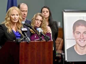 FILE – In this May 5, 2017, file photo, Centre County, Pa., District Attorney Stacy Parks Miller, left, announces findings an investigation into the death of Penn State University fraternity pledge Tim Piazza, seen in photo at right, as his parents, Jim and Evelyn Piazza, second and third from left, stand nearby during a news conference in Bellefonte, Pa. Parks Miller reinstated certain charges against members of Penn State's former Beta Theta Pi fraternity Friday, Oct. 27, 2017, nearly two months after a district judge dismissed the most serious charges of involuntary manslaughter and aggravated assault originally filed by prosecutors in response to the Feb. 4, 2017, death of 19-year-old Tim Piazza, of Lebanon, N.J., after a night of heavy drinking. (Abby Drey/Centre Daily Times via AP, File)