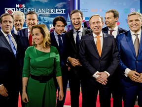 FILE- In this Tuesday March 14, 2017, file photo Democrats 66 party leader Alexander Pechtold, right-wing populist leader Geert Wilders, Socialist Party leader Emile Roemer, Party for the Animals' Marianne Thieme, Green Left party leader Jesse Klaver, Dutch Prime Minister Mark Rutte, Gert-Jan Segers of the Christian Union, Labour Party leader Lodewijk Asscher, and Christan Democrats party leader Sybrand Buma, from left, pose for a picture after the closing debate at parliament in The Hague, Netherlands. The leaders of four parties negotiating to form the next Dutch government have reached agreement on a draft program for a new center-right coalition, after 208 days of negotiations. (Robin van Lonkhuijsen ANP POOL via AP, File)