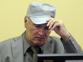 FILE- In this Friday, June 3, 2011, image former Bosnian Serb Gen. Ratko Mladic removes his hat in the court room during his initial appearance at the U.N.'s Yugoslav war crimes tribunal in The Hague, Netherlands. A United Nations war crimes tribunal will deliver its verdicts on Nov. 22, 2017, in the long-running trial of former Bosnian Serb military chief Mladic. Mladic was tried on 11 counts including genocide, murder and terror for allegedly overseeing atrocities by Serb forces in Bosnian's 1992-95 war that left 100,000 dead. (AP Photo/Martin Meissner, Pool)