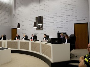 Presiding Judge Renckens, center, opens the court session in The Hague, Netherlands, Monday, Oct. 30, 2017, in the case against a Dutch national of Ethiopian descent for alleged war crimes committed during the 1970's regime in Ethiopia. (AP Photo/Peter Dejong)