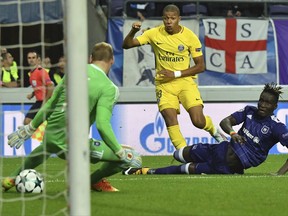 PSG's Kylian Mbappe, center, scores his side's first goal passing Anderlecht goalkeeper Matz Sels, left, and Anderlecht's Kara Mbodji, right, during a Champions League Group B soccer match between Anderlecht and Paris Saint-Germain at the Constant Vanden Stock stadium in Brussels, Belgium, Wednesday, Oct. 18, 2017. (AP Photo/Geert Vanden Wijngaert)